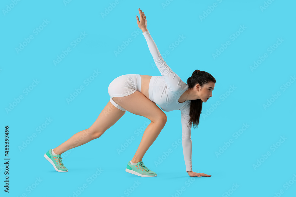 Sporty female runner on color background