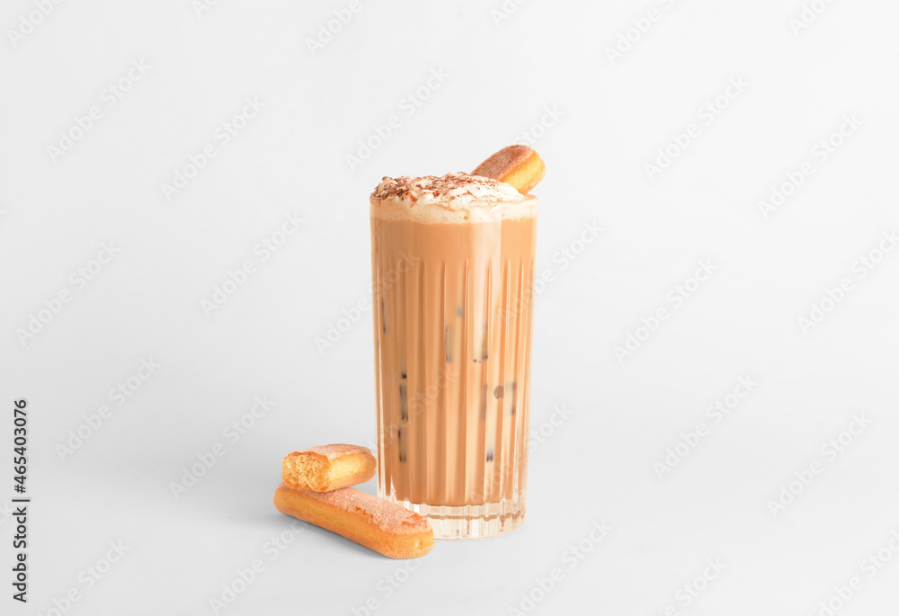 Glass of tasty Tiramisu Latte on light background