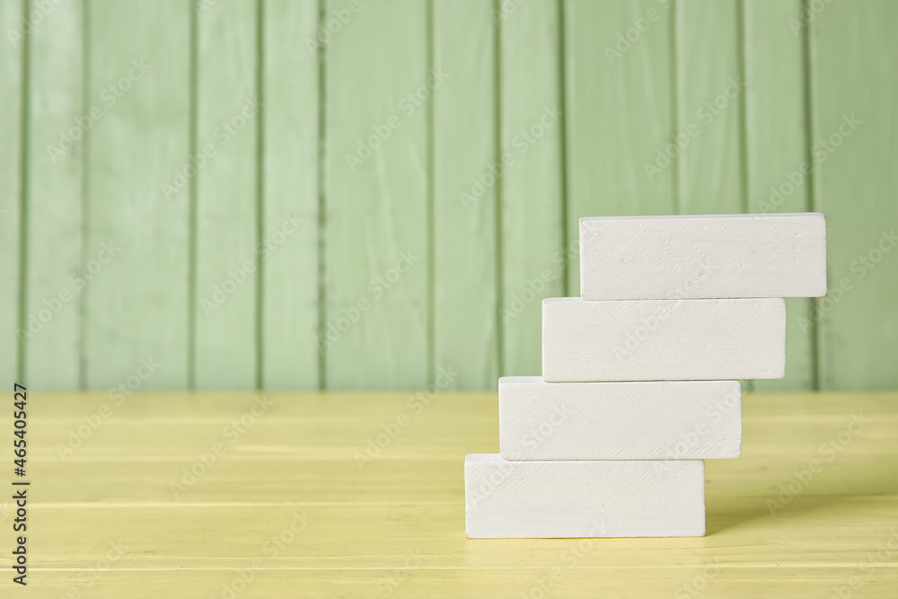 White blocks on color wooden background