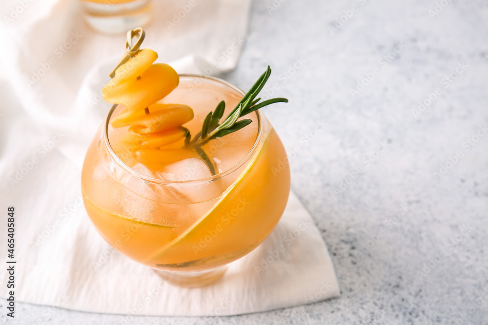 Glass of tasty melon cocktail on light background