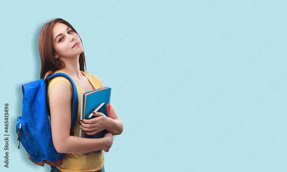 Young smiling happy girl teen student hold books