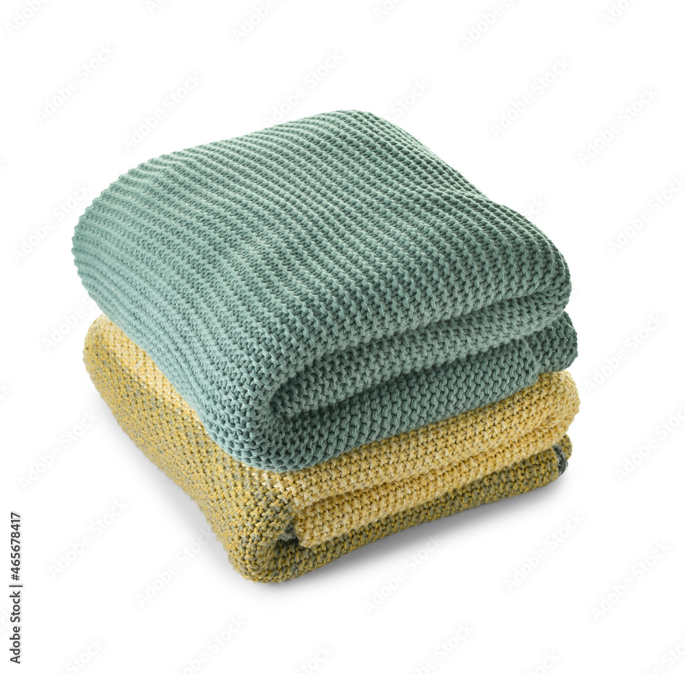 Soft folded blankets on white background