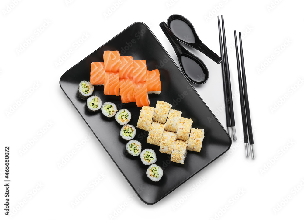 Plate with delicious sushi rolls on white background