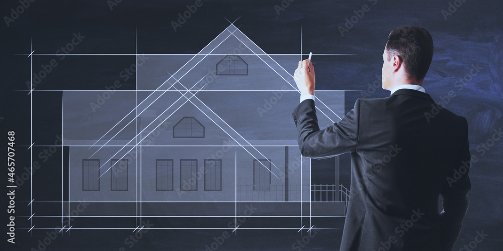 Businessman drawing creative house project blueprint on black background. Construction, architecture