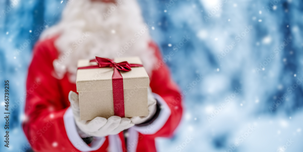 Santa Claus holding in his hands present box.