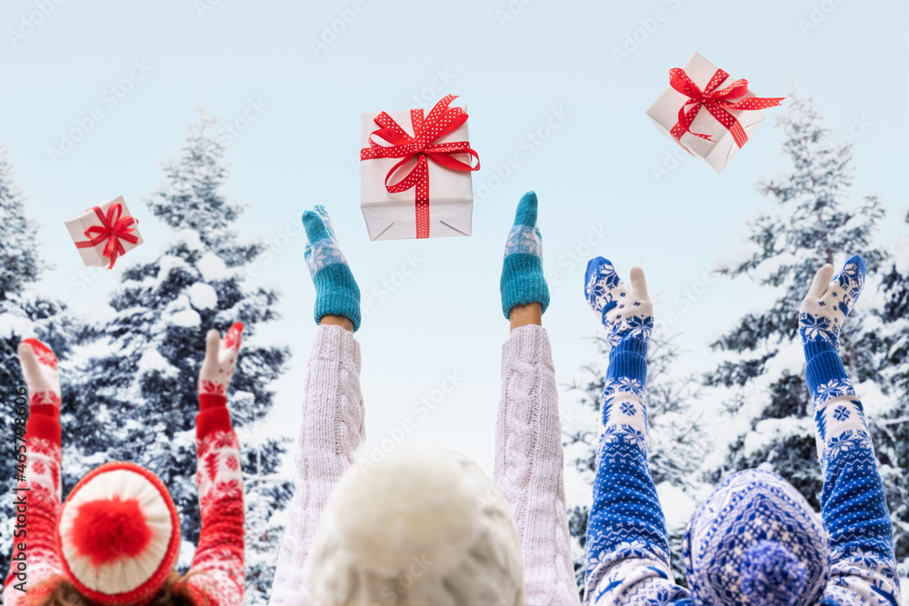 Happy family throw up Christmas gift boxes outdoor