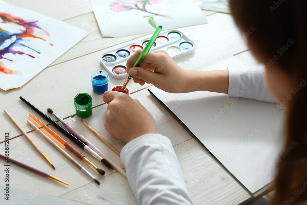 Cute little girl painting at home, closeup