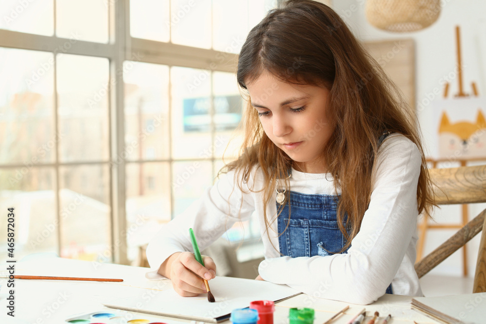 Cute little girl painting at home