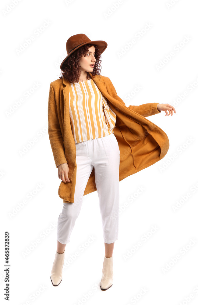 Fashionable woman in felt hat looking away on white background