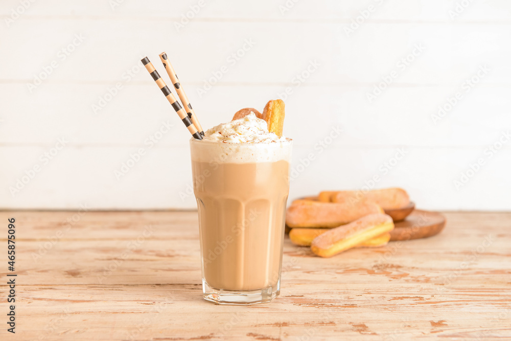 Glass of tasty Tiramisu Latte on table