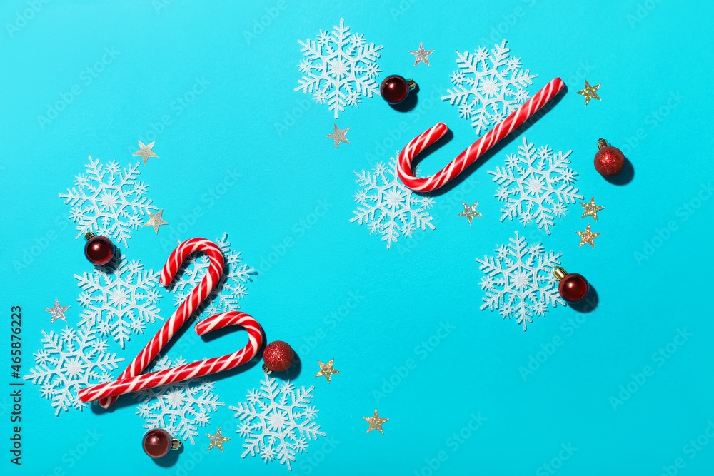 Composition with candy canes and decorations on color background