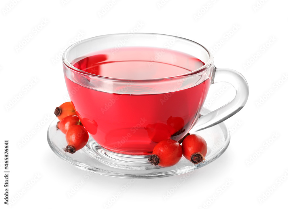 Glass cup of tasty rose hip tea and berries on white background