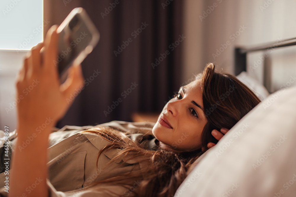 Adult woman, turning on her phone in the morning