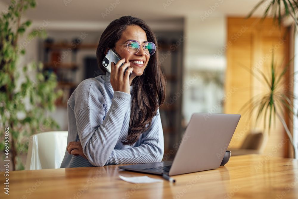 Business woman making phone call, while working at the office.