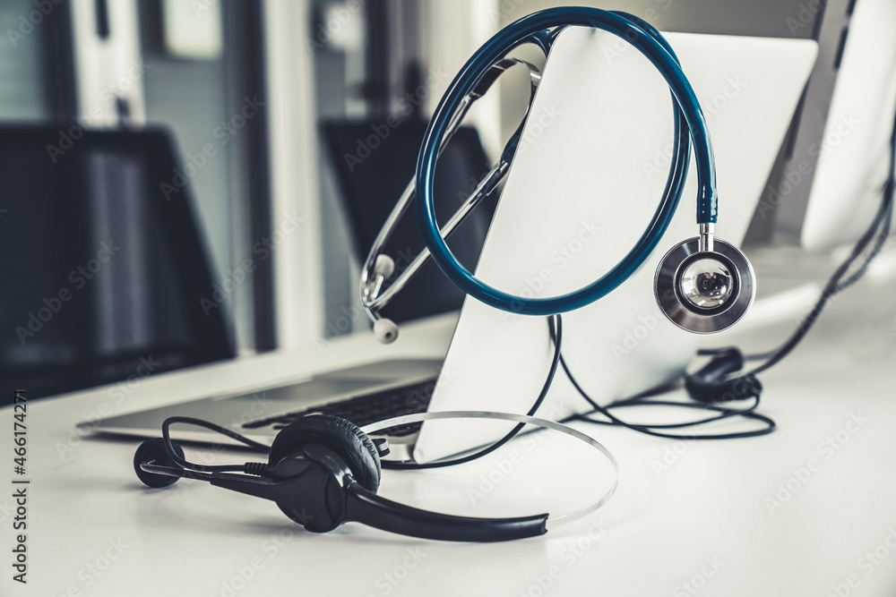 Headset and doctor equipment at clinic ready for actively support for patient by online video call .