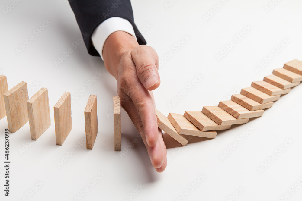 hand stop domino effect. risk management and security concept.