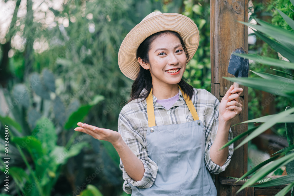 Young Asian woman takes care of the garden