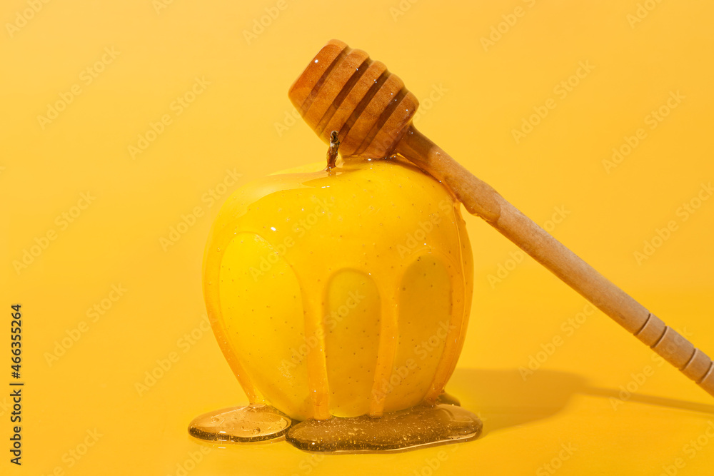 Ripe apple with sweet honey and dipper on color background