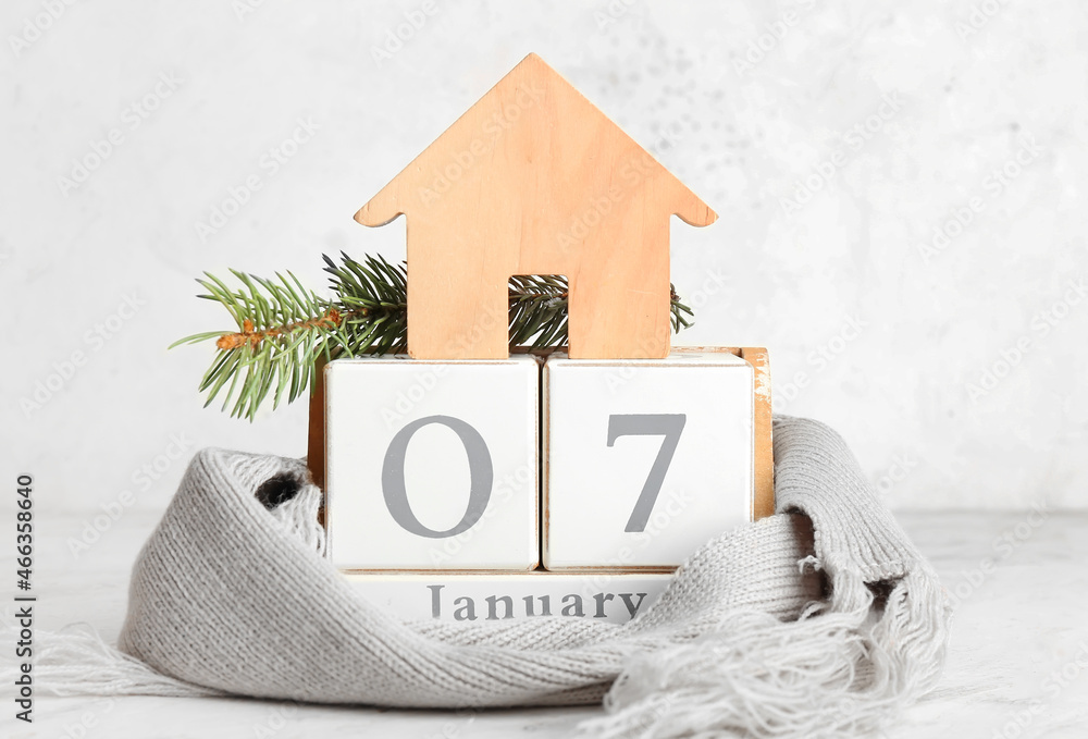 House figure with calendar, fir branches and scarf on white background. Winter concept