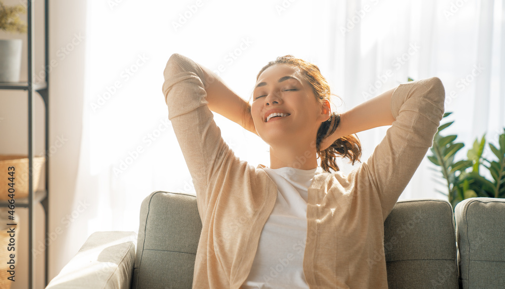 woman resting on armchair at home