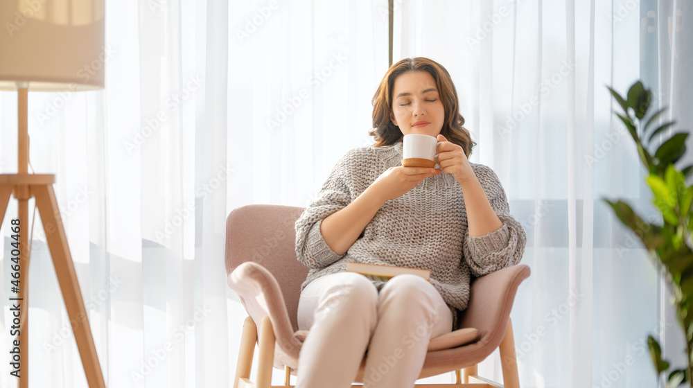 woman resting on armchair at home