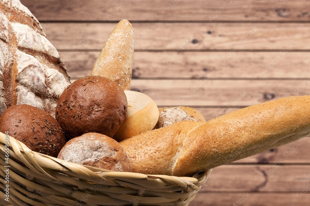 Fresh loaves of bread with wheat and gluten on a table