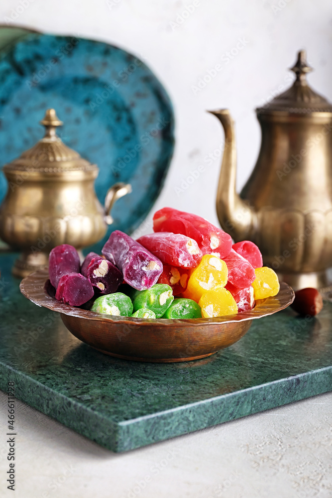 Plate with tasty Turkish delight on table