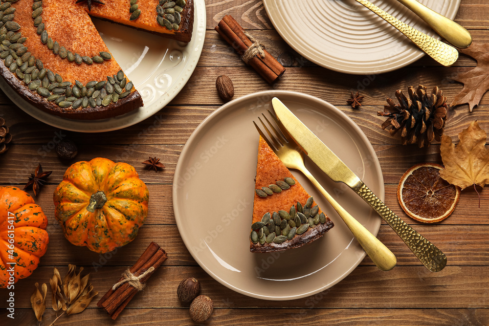 Beautiful autumn composition with piece of tasty pumpkin pie on wooden background