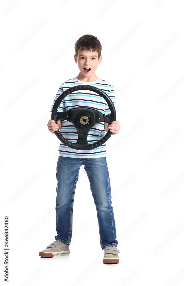 Surprised little boy with steering wheel on white background