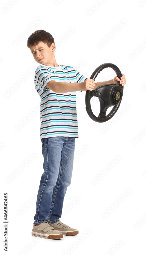 Cute little boy with steering wheel on white background