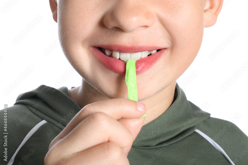 Little boy chewing gum on white background, closeup