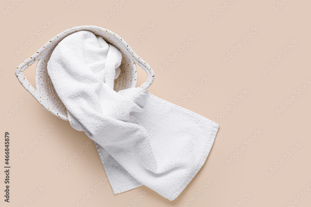 Basket with white clean towel on color background