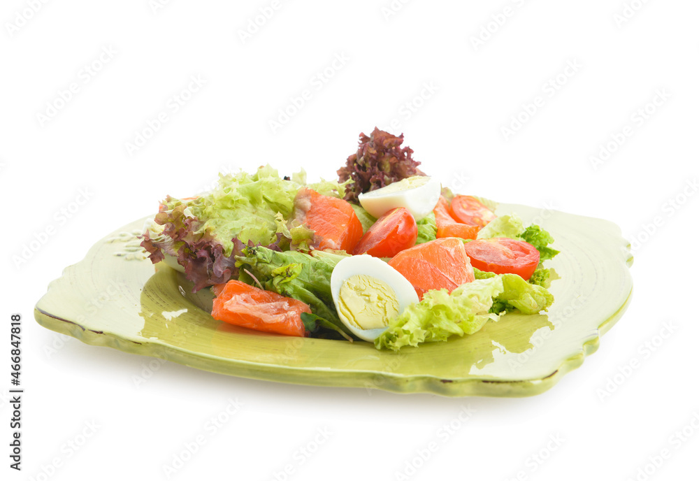 Tasty salad with salmon and fresh vegetables in plate on white background