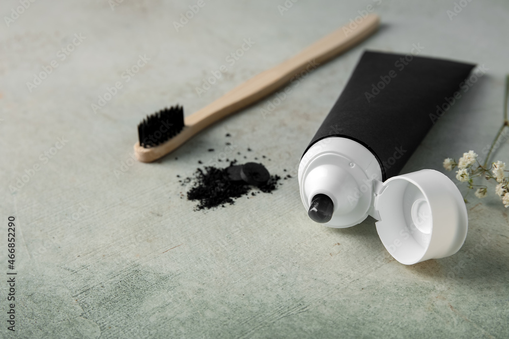 Black toothpaste with activated carbon and brush on table