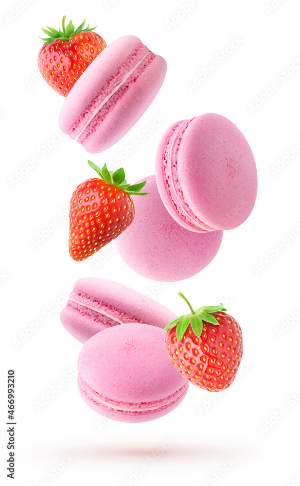 Isolated fruit macaroons. Falling pink macaroons and fresh straberries isolated on white background