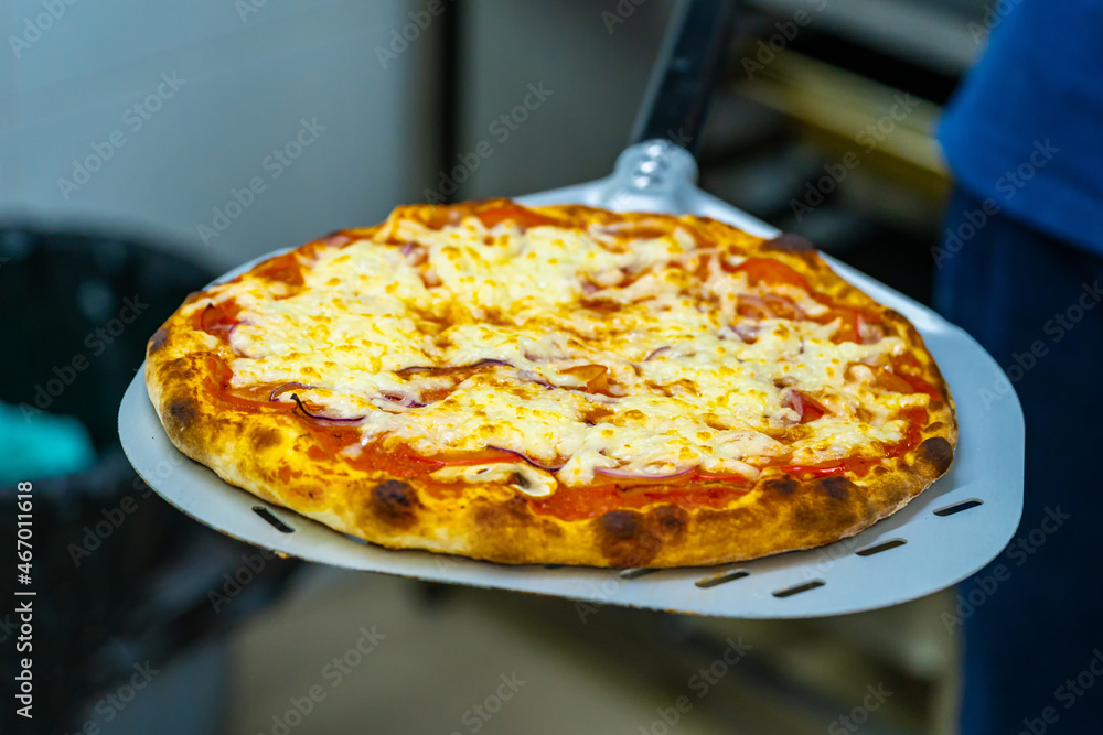 Yummy close up of pizza. Close up view of tasty grilled lunch with cheese.