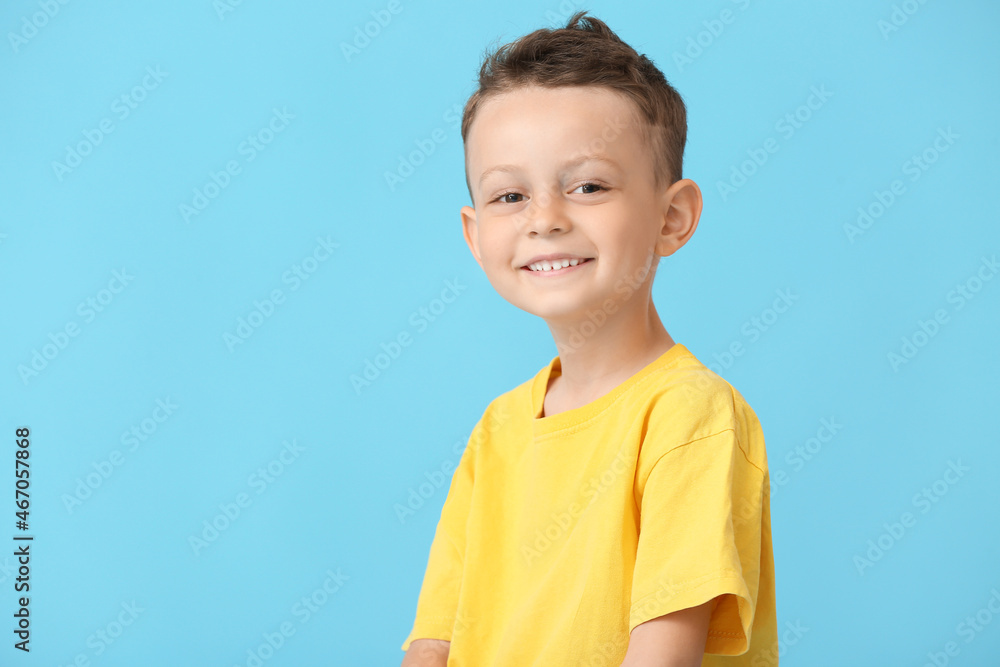 Portrait of happy little boy on color background