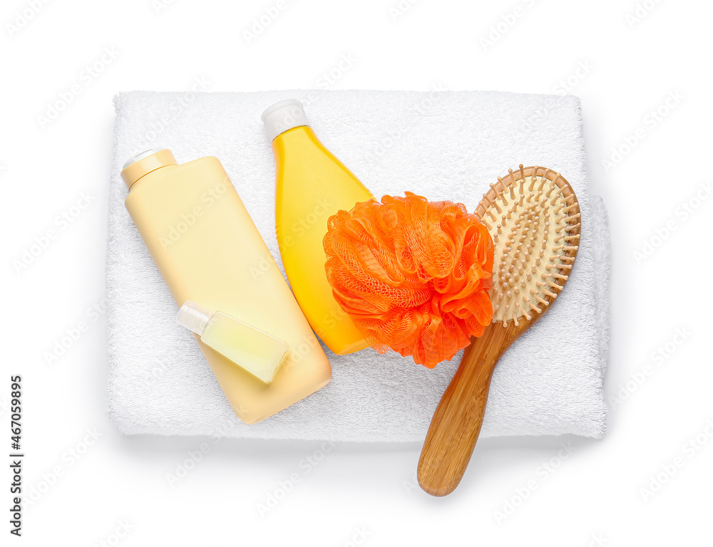 Set of bath supplies with orange sponge on white background