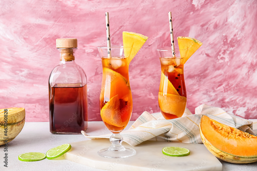 Glasses with delicious melon cocktail on color background