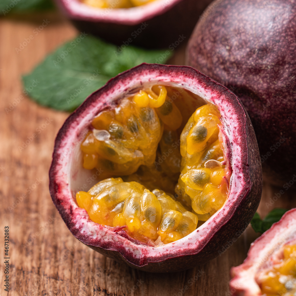 Delicious juicy passion fruit on wooden table background.