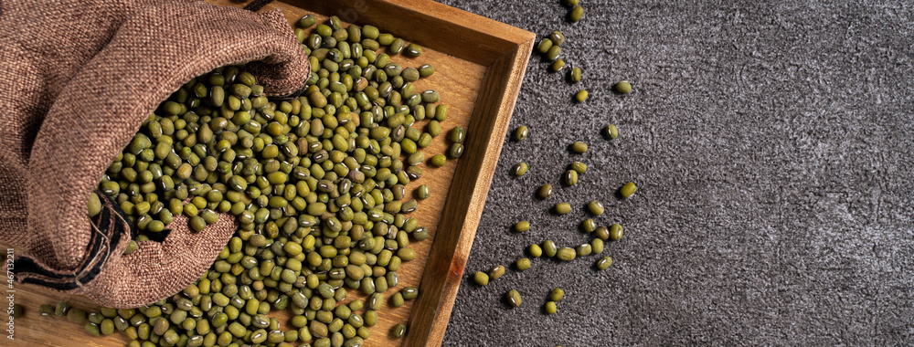 Raw mung bean on wooden table background.