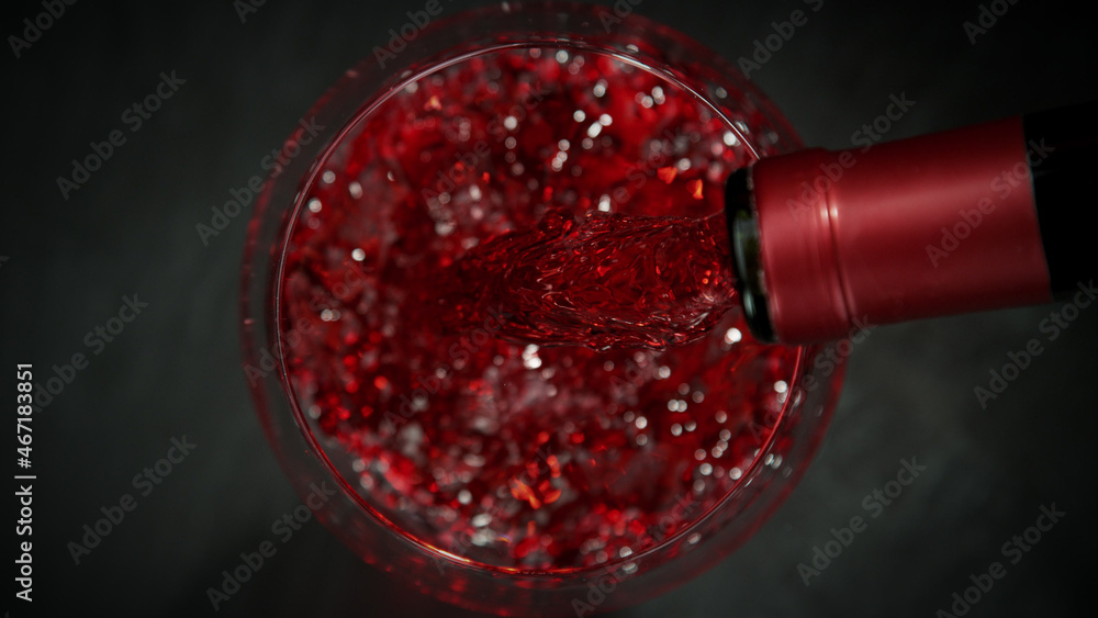 Top shot of pouring red wine into glass.