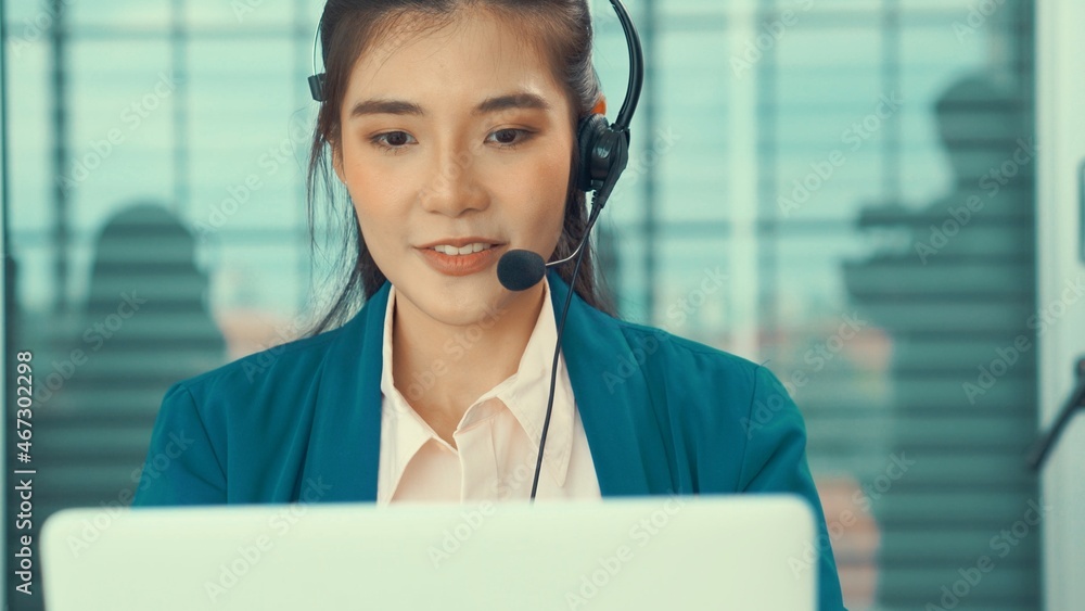 Businesswoman wearing headset working actively in office . Call center, telemarketing, customer supp