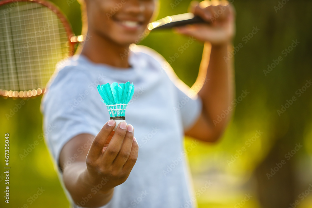 Young African-American man playing badminton outdoors