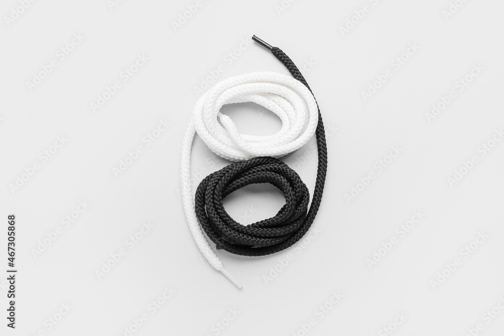 Rolls of shoe laces on white background