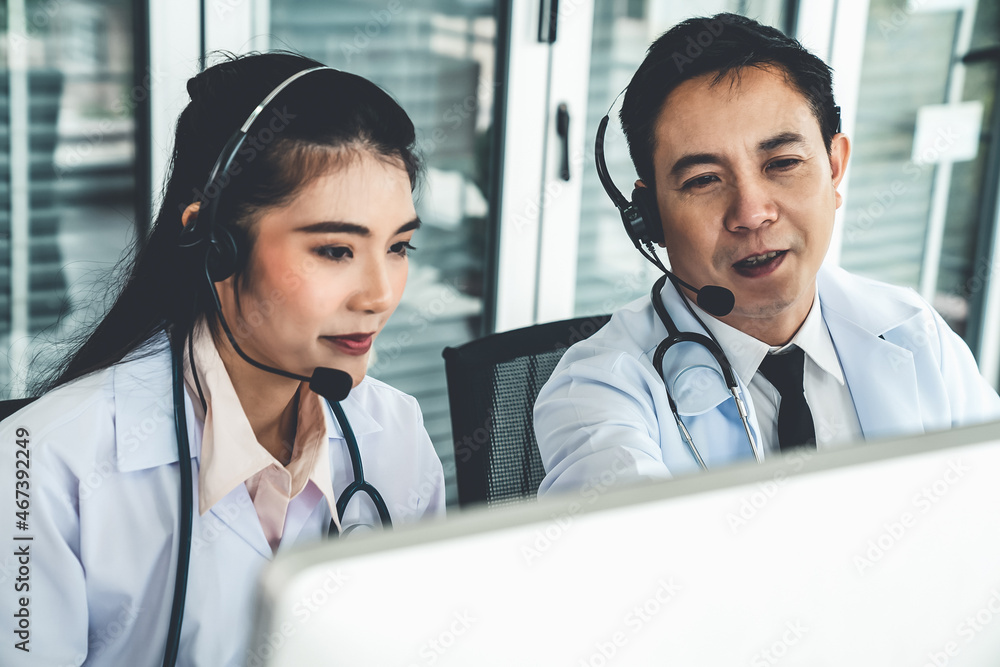 Doctor team wearing headset talking actively on video call in hospital clinic . Concept of telehealt