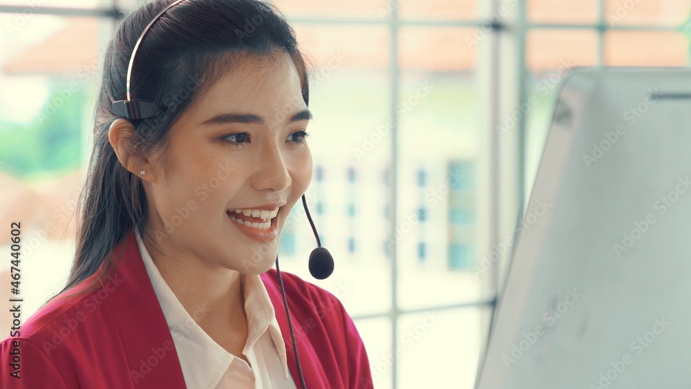 Businesswoman wearing headset working actively in office . Call center, telemarketing, customer supp