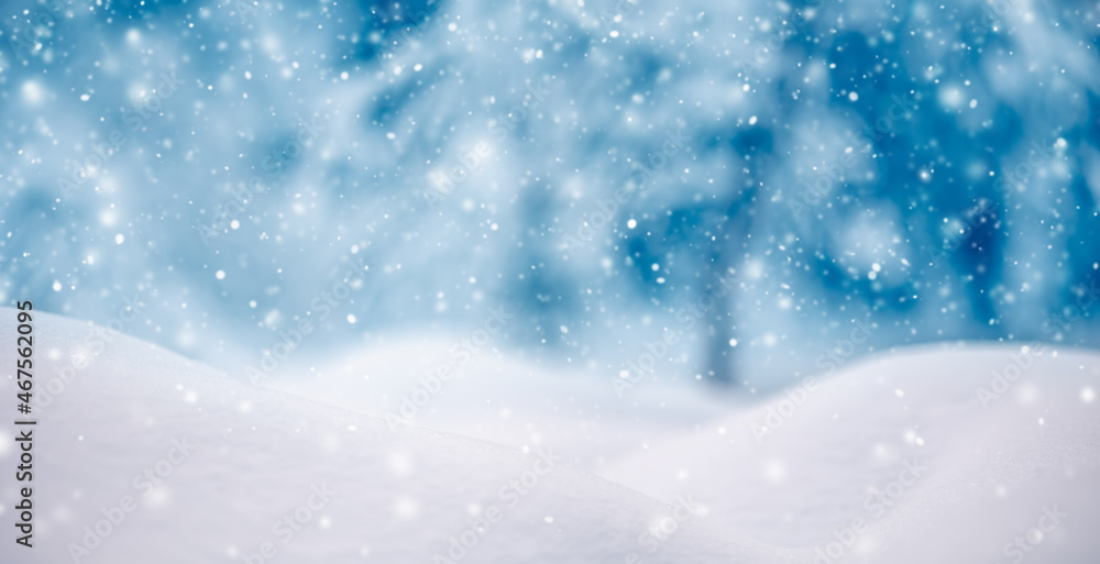 Snowy background with closeup view of the wavy snowdrifts in snowfall.