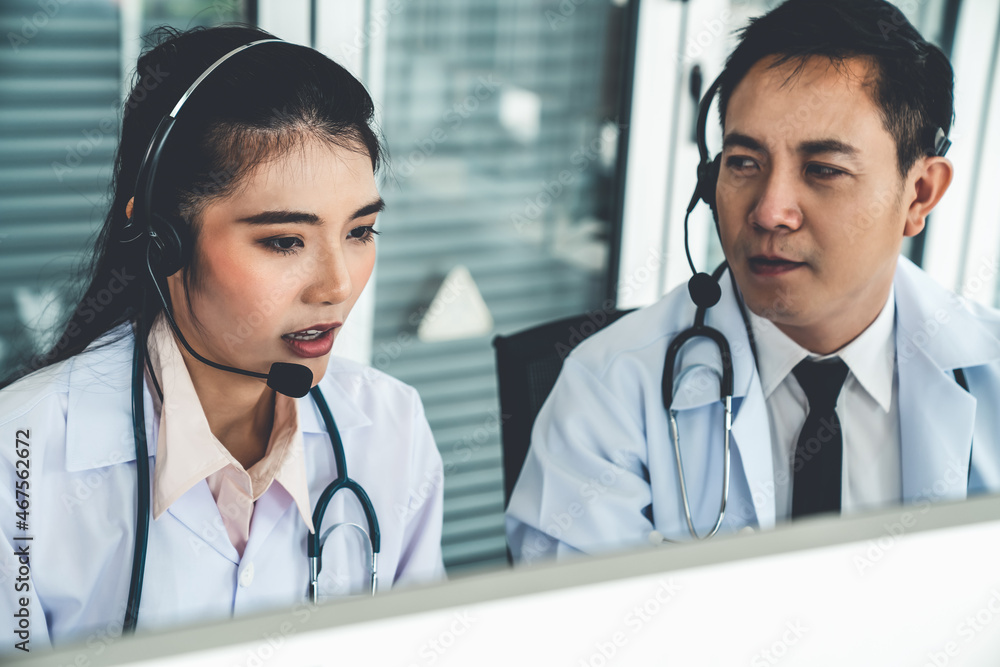 Doctor team wearing headset talking actively on video call in hospital clinic . Concept of telehealt