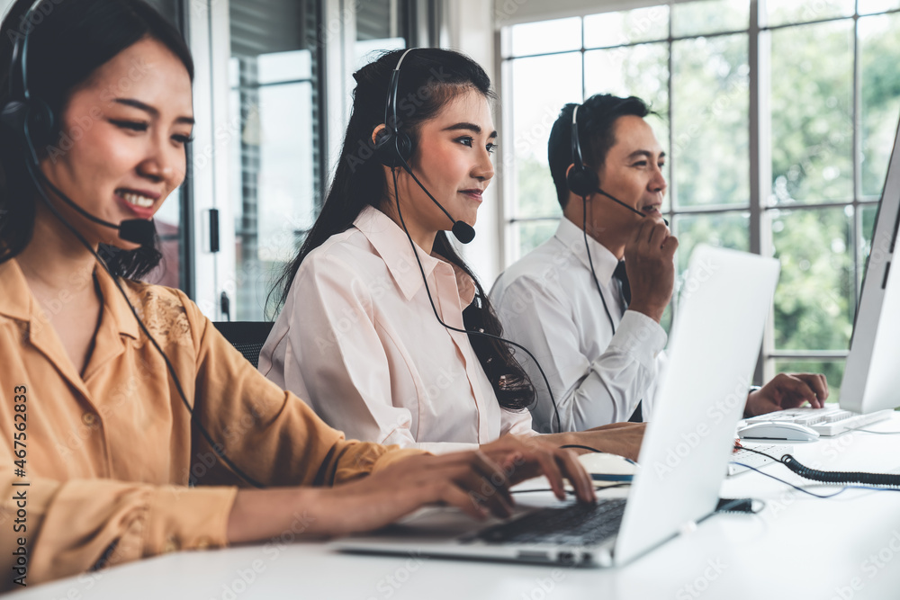 Business people wearing headset working actively in office . Call center, telemarketing, customer su